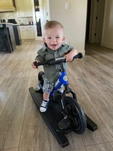 Baby enjoying cycle ride | Elite Builder Services